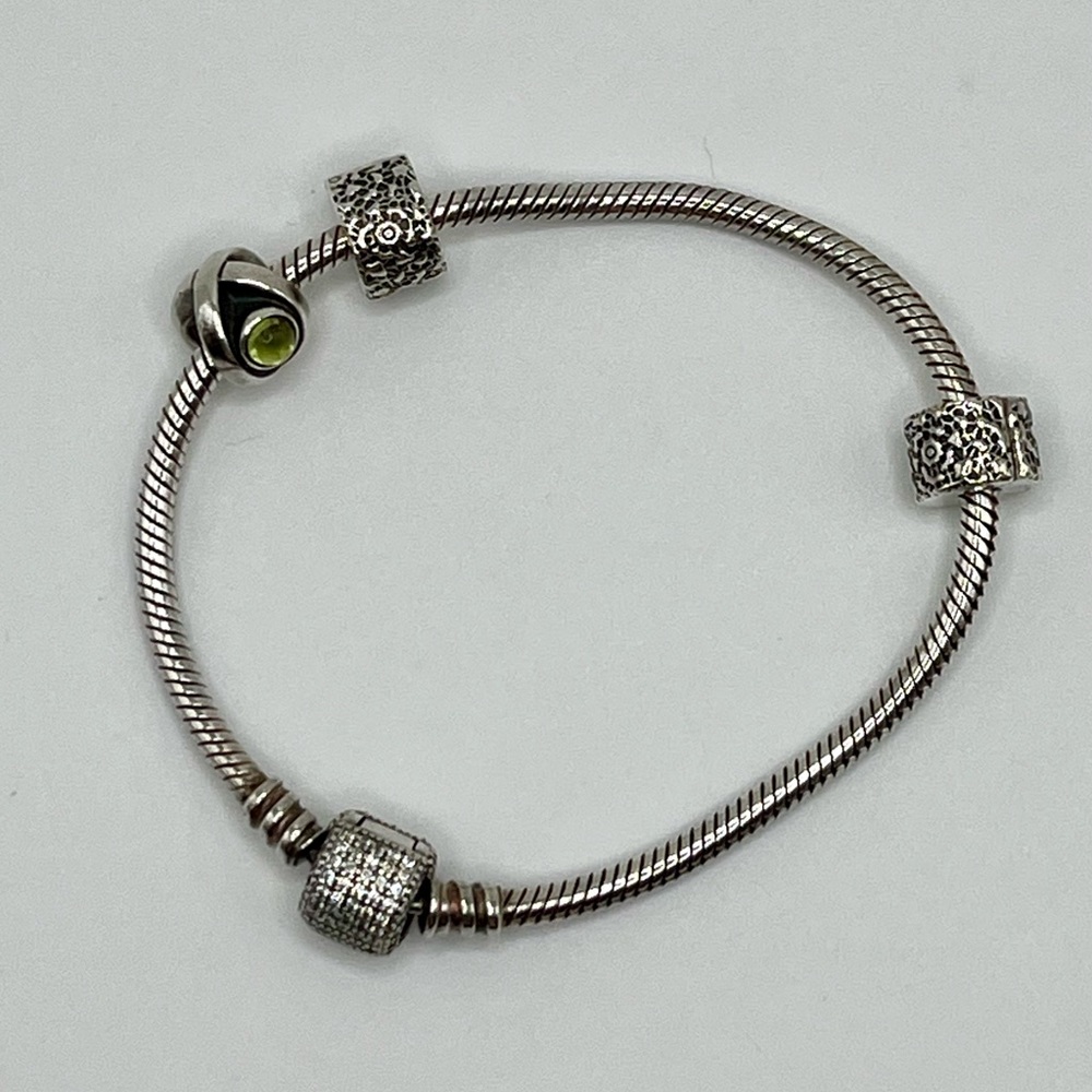 Authentic Pandora bracelet, two stoppers and retired Green Peridot Eye Charm